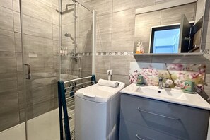 Shower, hair dryer, towels, toilet paper