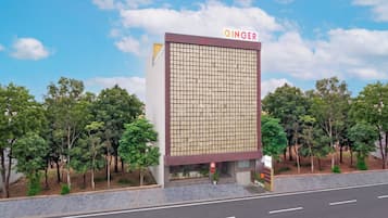 A building with a grid-patterned facade and a sign reading 'GINGER' at the top.