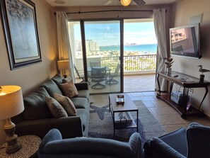 A living room with a sofa, a coffee table, and a TV on a stand. - Casa Blanca D 602 ·  Sandy Beach 2 bedroom (Puerto Peñasco)
