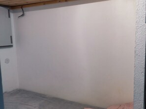 Comfortable accommodations feature a wooden ceiling and a textured wall.