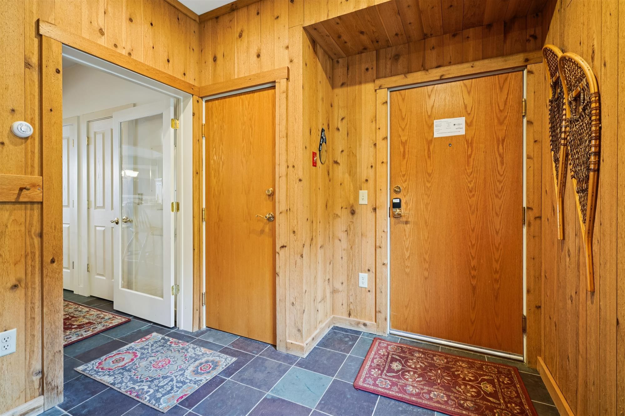 Welcoming Entryway - Warm wood finishes and mountain-inspired details create an inviting first impression as you arrive at your Vermont retreat.