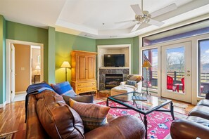 Living Room with Mountain Views - Floor-to-ceiling glass doors invite the outdoors in, offering scenic views and easy access to the private balcony.