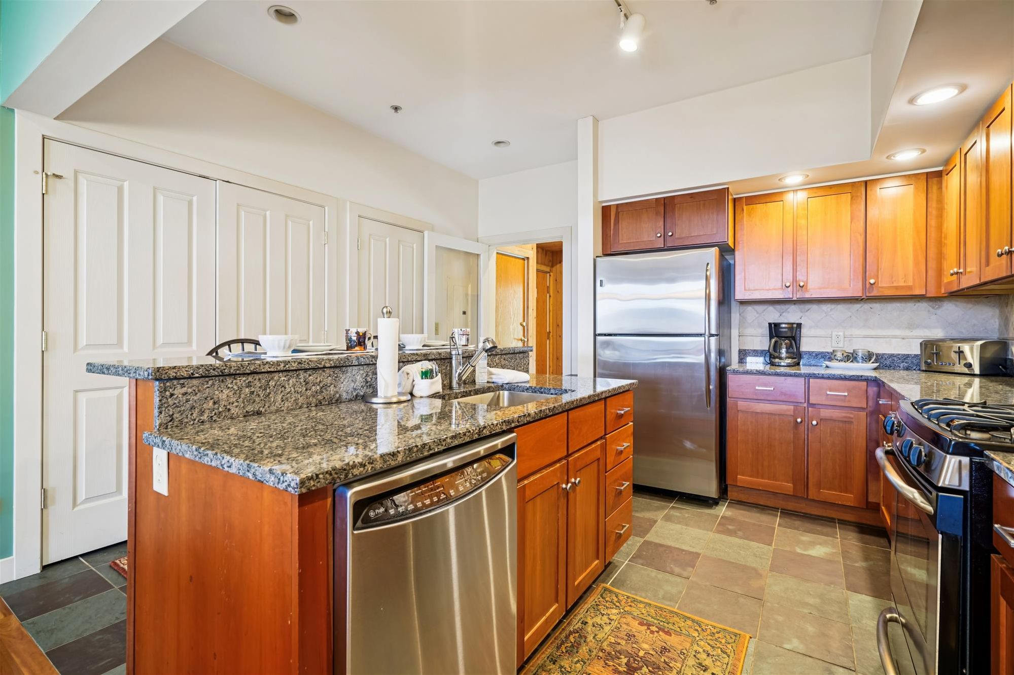 Gourmet Kitchen - Granite countertops, stainless appliances, and a spacious island create a beautiful kitchen designed for gathering, cooking, and entertaining.