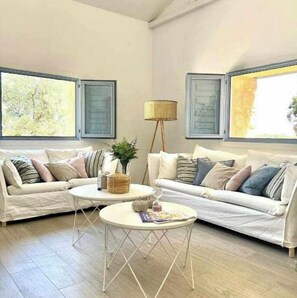 Relax in this inviting living room with two sofas, a coffee table, and a cozy reading nook.