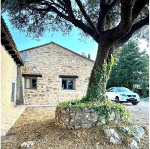 Situated in a serene natural setting, this charming building features a traditional pitched roof and a small window.