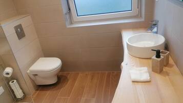 Shower, hair dryer, towels, toilet paper