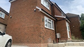 A two-story brick house with a white car parked in front. - Wagtail Way Kent (Orpington)