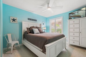 A bedroom with a bed, a chair, a dresser, and a ceiling fan. - Gorgeous 4 bedroom oceanfront house with pool - Ponce Inlet Beach House (Ponce Inlet)