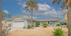 A single-story house with a garage, a covered porch, and a small patio area. - Gorgeous 4 bedroom oceanfront house with pool - Ponce Inlet Beach House (Ponce Inlet)