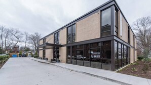 A modern building with large windows and a brick facade. - This serviced apartment is a 2 bedroom(s), 2 bathrooms, located in Lexington, KY. (Lexington)