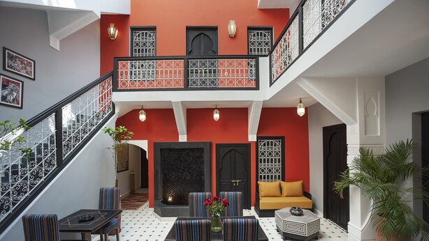A multi-level interior with a staircase, seating area, and a fireplace. - Riad Mylaya (Marrakech)