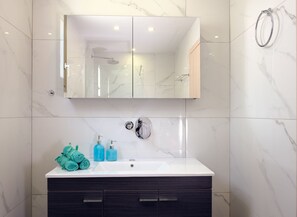 Bathtub, eco-friendly toiletries, hair dryer, towels