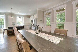 Enjoy meals with family and friends at the large dining table in this well-equipped kitchen.