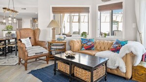 A cozy living room with a wicker chair, a sofa, and a coffee table. - ** Prices dropped $300 per week, for all remaining 2023 weeks. Prices shown include the discount. **<br>Avalon Penthouse 803 - 1 of a kind 3 br/3 bath with huge balcony and incredible views. (Ocean City)