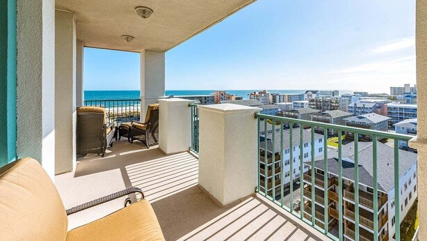 A balcony with a view of the ocean and cityscape. - ** Prices dropped $300 per week, for all remaining 2023 weeks. Prices shown include the discount. **<br>Avalon Penthouse 803 - 1 of a kind 3 br/3 bath with huge balcony and incredible views. (Ocean City)