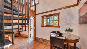 A dining area with a wooden table, chairs, and a window with a view of trees. - Patio & Mtn Views: Peaceful Sedona Retreat (Sedona)