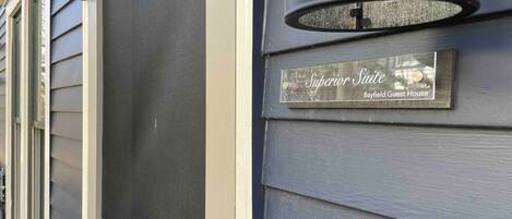 A house number '5' and a plaque on the wall that reads 'Superior Suite Bayfield Guest House'.