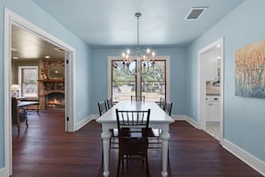 Enjoy meals in this elegant dining room with a large window offering a view of the outdoors.