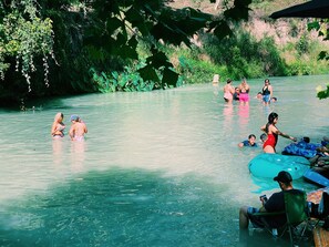 A group of people in a natural water body surrounded by greenery. - 3 Blue River Camp - Glamping Cabin (Kingsbury)