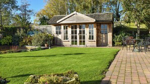 A small, single-story building with a brick facade, large windows, and a well-maintained lawn. - 3 bedroom accommodation in Ashbourne (Ashbourne)