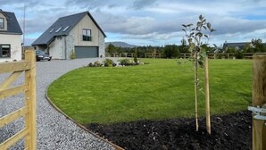 A residential area with a house featuring a garage and a driveway.