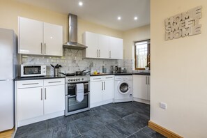 Fridge, microwave, cookware/dishes/utensils, dining tables - Charming 2-Bedroom Home in Truro (Truro)