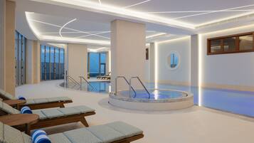 Indoor pool, open 6:00 AM to 11:00 PM, pool loungers