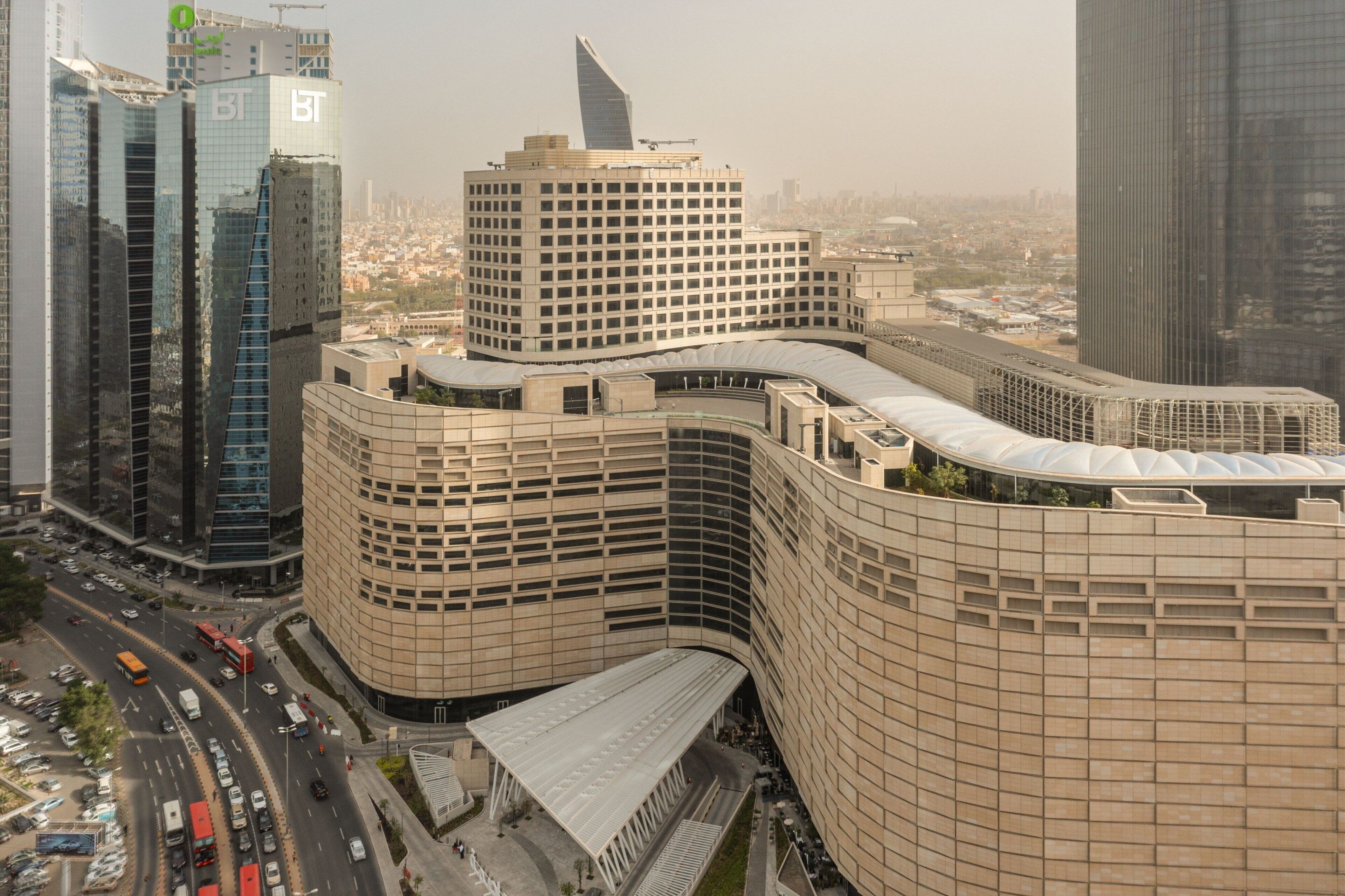 A modern building with a curved facade, multiple floors, and a prominent BT logo.