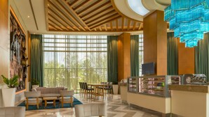 A modern hotel lobby with a seating area, a buffet, and large windows. - Four Points By Sheraton Ikot Ekpene (Ikot Ekpene)