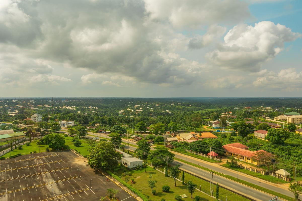 A residential area with houses, roads, and a large parking lot.