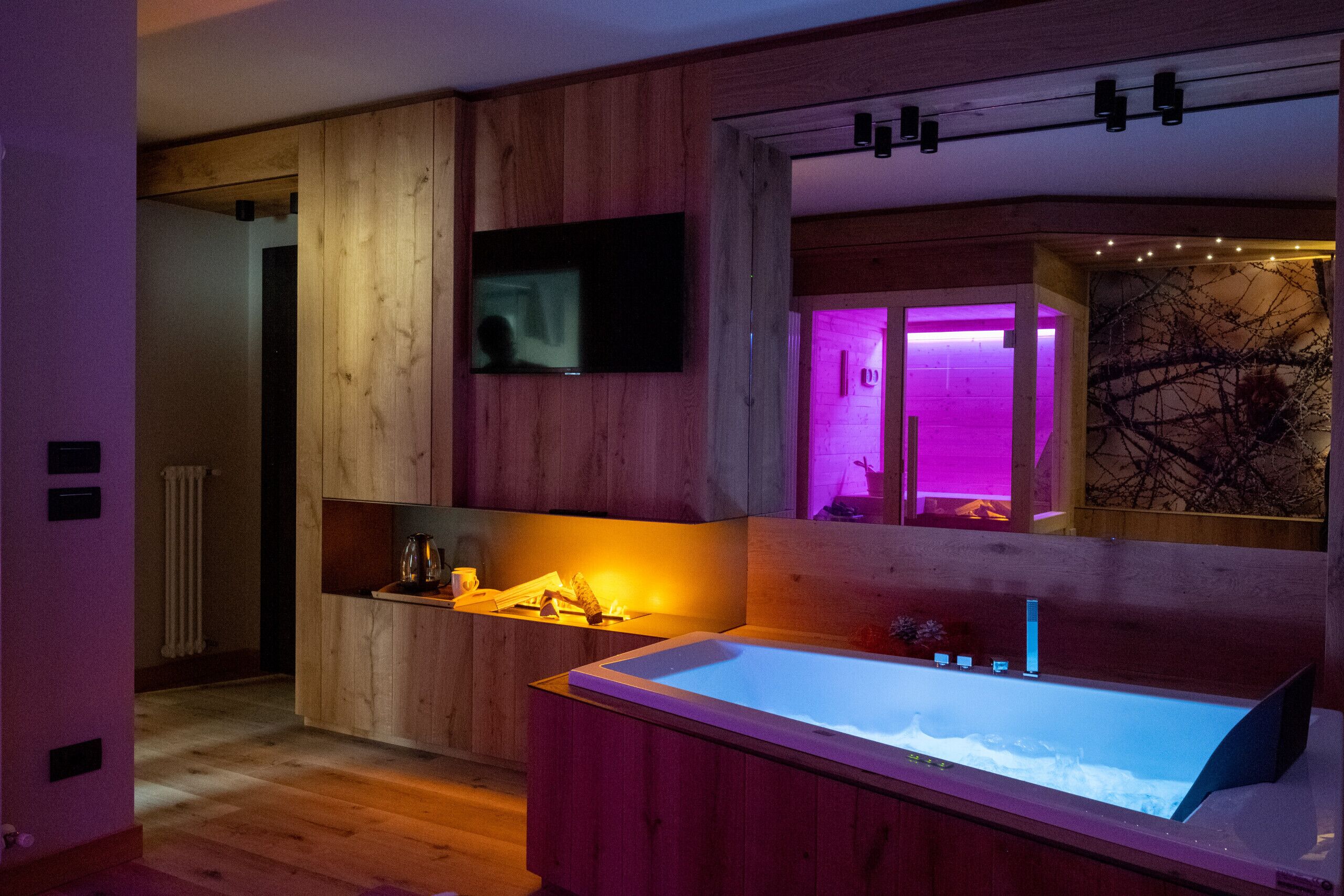 A modern bathroom with a wooden interior, a large bathtub, and a mirror.