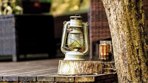 A lantern on a wooden platform next to a tree. - 1 bedroom accommodation in Woolton Hill, nr Newbury (Woolton Hill, nr Newbury)
