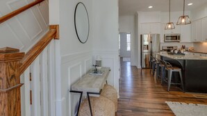 A spacious kitchen with a central island, stainless steel appliances, and pendant lighting. - Modern Luxury | Spacious Comfort | Prime Location (Nashville)