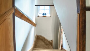A wooden staircase with a window at the top.