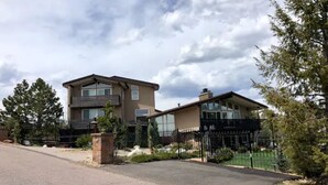 A two-story house with a driveway and a black metal fence. - Lookout Mountain Lodge & Chalet with Views! (30 Day Min) (Golden)
