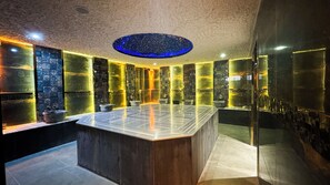 A modern bathroom with a marble vanity, a freestanding bathtub, and a unique ceiling design. - Side Mira Palace (Manavgat)