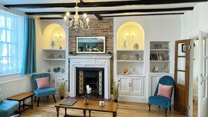 A traditional living room with a fireplace, wooden furniture, and decorative items. - This property is completely unique. (Scarborough)