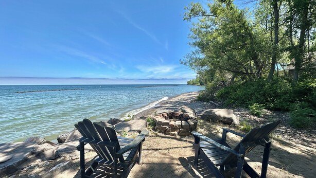 A lakeside setting with Adirondack chairs and a fire pit. - Island Sandbar retreat with sunset views, water toys and more! Boat-Only Access (Wolcott)