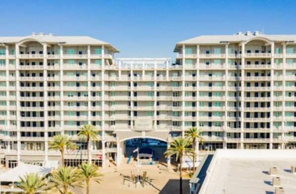 A large, multi-story hotel with a symmetrical facade, numerous balconies, and a central entrance.