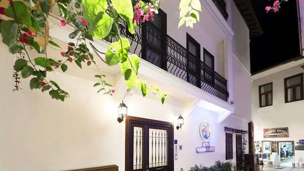 A hotel with a balcony, a sign indicating it is a hotel, and a street in front. - Rodina Suites (Kusadasi)