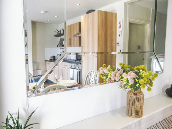 A kitchen with wooden cabinets, a stove, and a microwave.