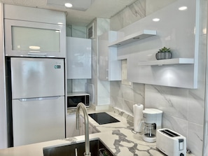 Fridge, microwave, stovetop, coffee/tea maker
