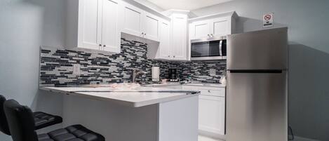 Fridge, microwave, stovetop, coffee/tea maker