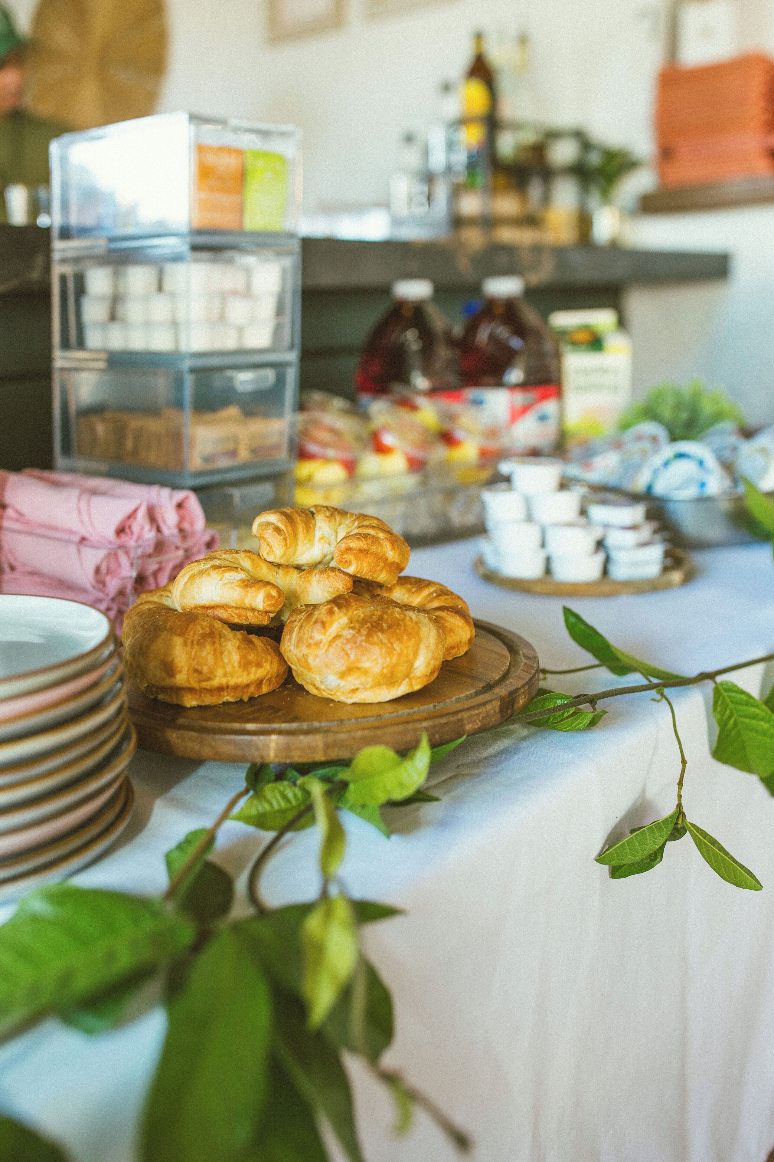 A breakfast buffet with pastries and condiments.
