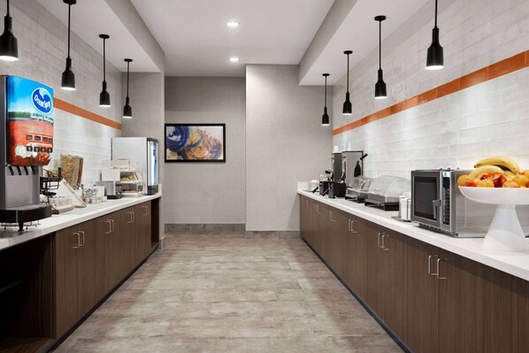 A modern kitchen with wooden cabinets, stainless steel appliances, and pendant lighting. - Hawthorn Extended Stay by Wyndham Del Rio (Del Rio)