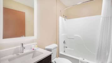 A bathroom with a sink, toilet, and bathtub.