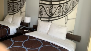 A hotel room with two beds, a nightstand with a lamp, and a wall with a large abstract artwork. - Super 8 by Wyndham Joliet (Joliet)