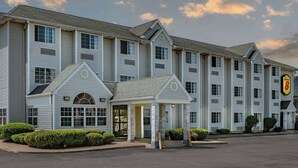 A multi-story hotel with a central entrance pavilion, large windows, and a sign indicating it is a Super 8 hotel. - Super 8 by Wyndham Joliet (Joliet)