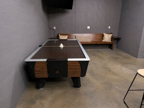 A pool table in a room with a bench and pillows. - The Gathering Place: Big Lakehouse/Covered Dock/Fiber/Tankless WH/Game RM/EV CHG (Cullman)