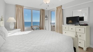 A bedroom with a large bed, a ceiling fan, a TV, and a dresser. - 🌴Gulf Views~Steps2Beach~Pool~Beach~Hot Tub~3BR Island Princess 315🌴 (Fort Walton Beach)